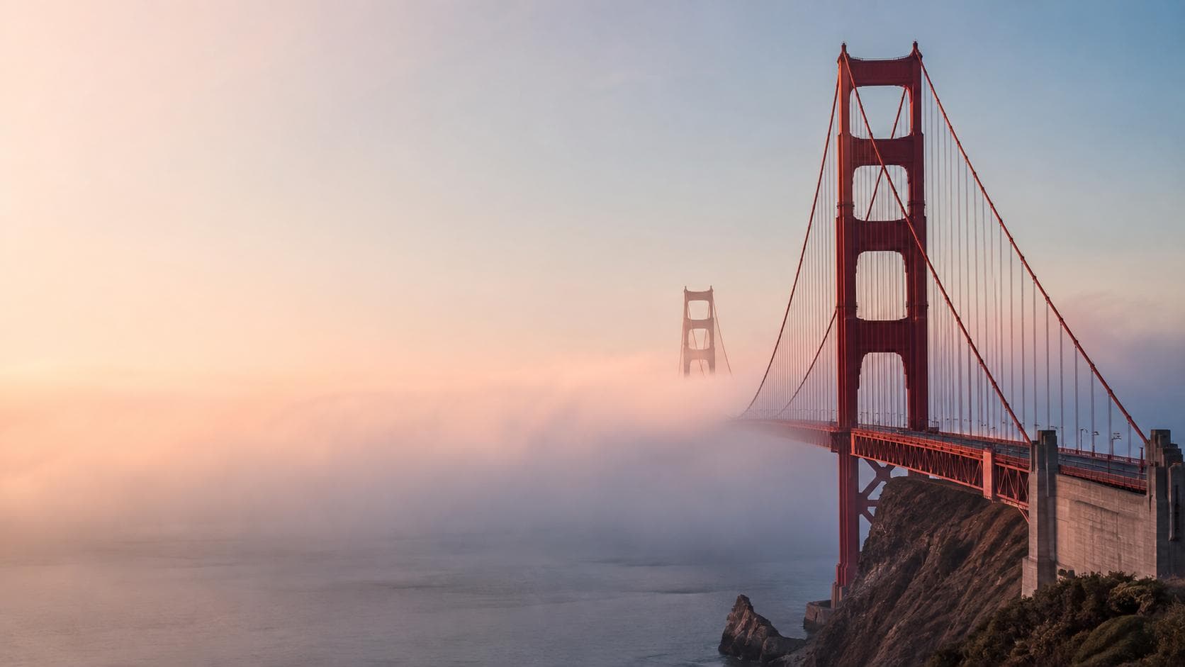 Golden Gate Bridge rising above San Francisco fog