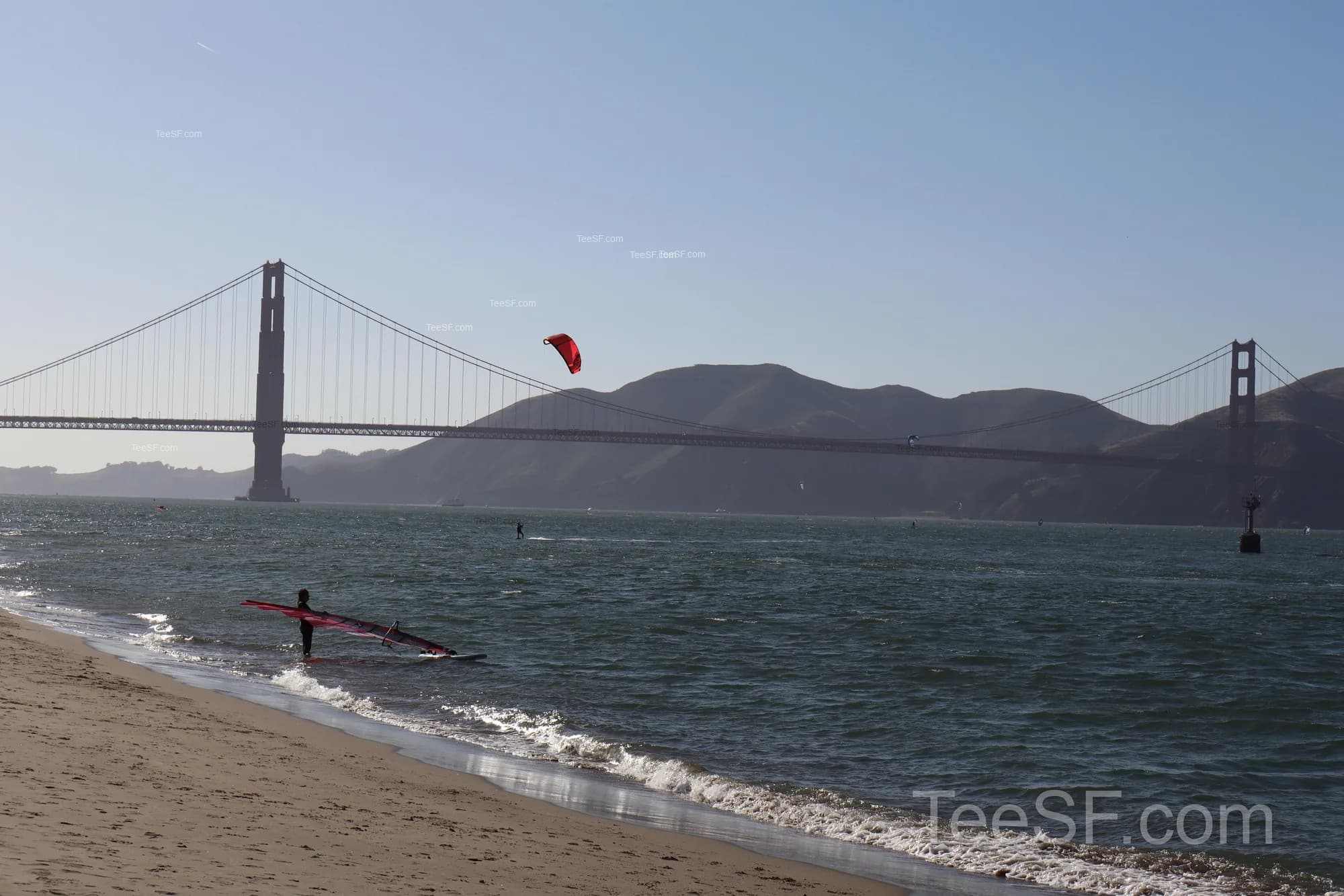 Golden Gate Bridge seen across the water from a San Francisco beach